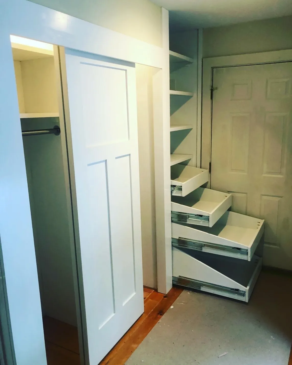 Custom full-extension pull-out shelving built into a closet.